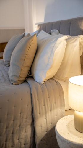 a couch with pillows on it in a living room at Hotel de Maître de Vaughan in Brussels