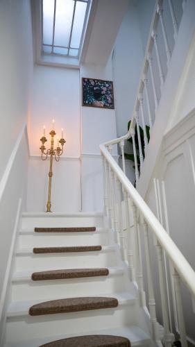 a white staircase with a cross and a window at Hotel de Maître de Vaughan in Brussels