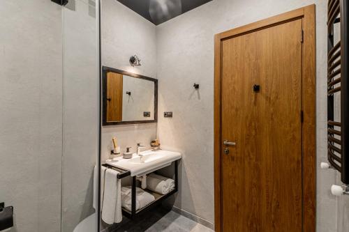 uma casa de banho com um lavatório e um espelho em Ivy Hotel em Tbilisi