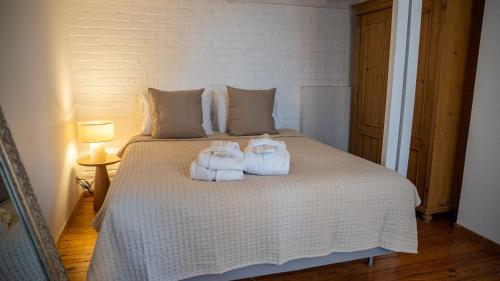 a bedroom with a bed with towels on it at Hotel de Maître de Vaughan in Brussels