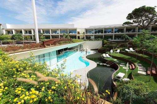 a large building with a swimming pool and a resort at Onyria Marinha Boutique Hotel in Cascais