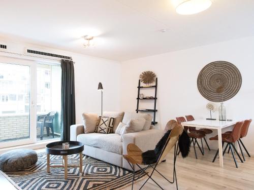 a living room with a couch and a table at Helena at Sea Apartments in Scheveningen
