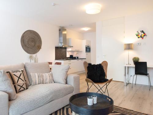 a living room with a couch and a table at Helena at Sea Apartments in Scheveningen