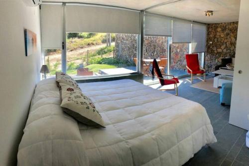 a bedroom with a large bed with a large window at Modern apartment with the best view. in Punta del Este