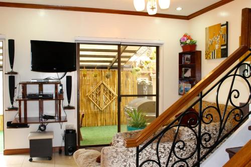 a living room with a sliding glass door at Eagle Ridge Family Vacation House in General Trias