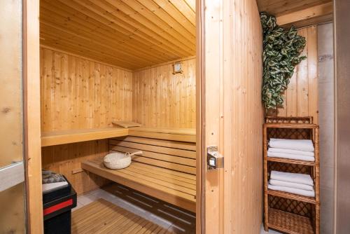 a sauna with wooden walls and wooden shelves and towels at Apartments Ladka in Begunje na Gorenjskem