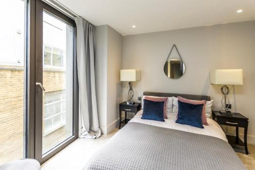 a bedroom with a bed and a large window at New Build-Air Con-2 Bedroom-Two Bathrooms Apt 2 in London