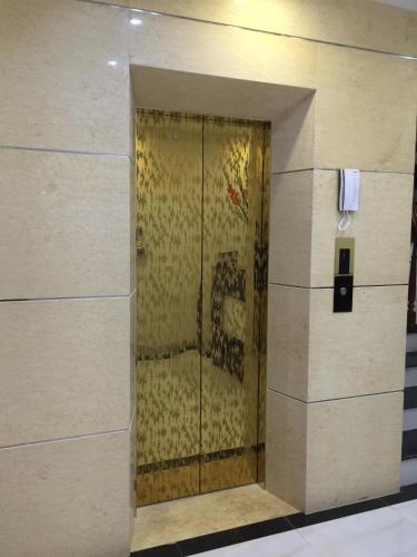 a door in a building with a painting on it at Dragon Airport Hotel in Noi Bai