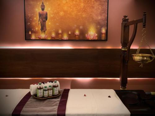 a room with a bed with a painting on the wall at Retrieve Health & Wellness in Cochin