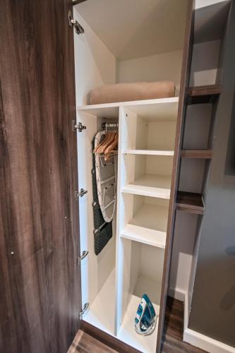 a walk in closet with white shelves at Les cles du 27 Paris in Paris