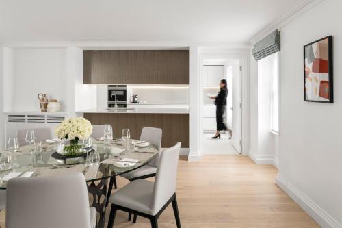 a kitchen and dining room with a table and chairs at COMO Metropolitan London in London