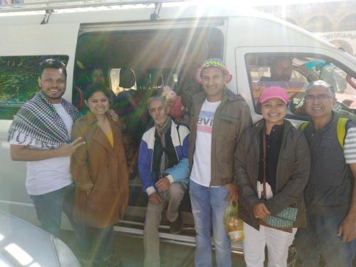 a group of people standing in front of a van at Aswan City Center Guest House in Aswan