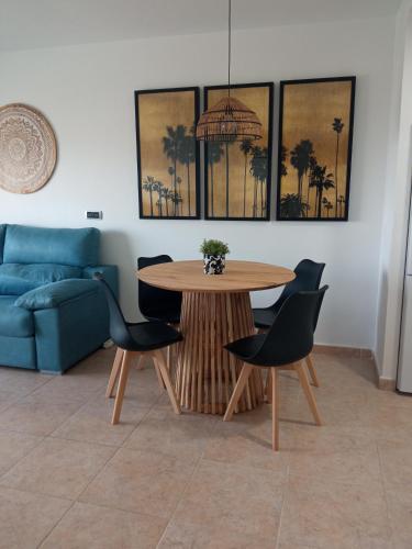 a living room with a table and chairs and a couch at SAHARA BEACH, sunrise & mediterranean sea views in La Manga del Mar Menor