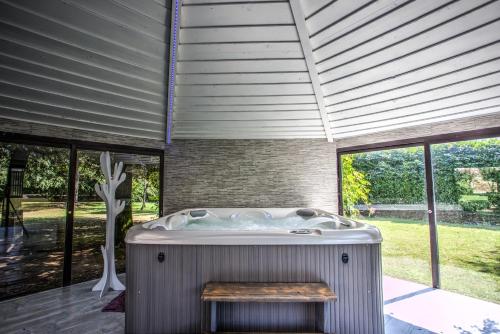 a jacuzzi tub in a room with windows at Villa Giuliana in Arezzo