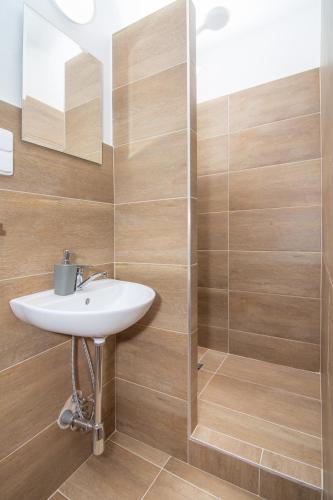 a bathroom with a sink and a shower at Penzion Anareta in Frýdek-Místek