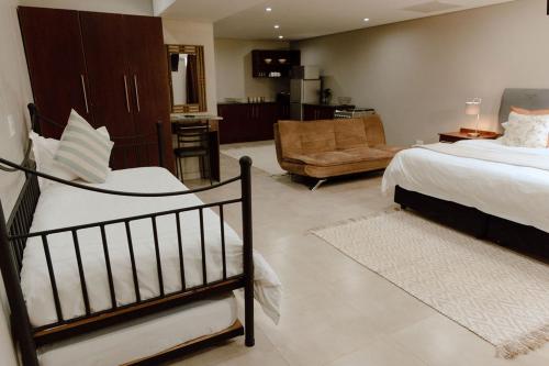 a bedroom with a bed and a living room at Marjaniek Wedding Venue & Guest House in Rietfontein
