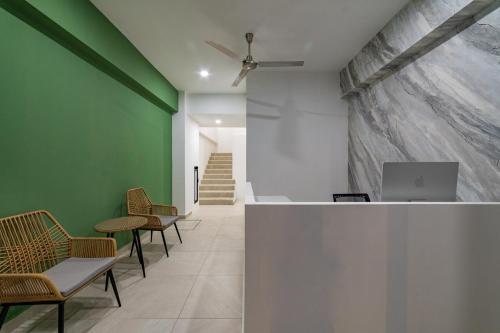 a lobby with chairs and a desk with a laptop at Mi Querida Maribel Hotel in Santa Cruz Huatulco