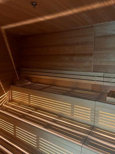 an empty sauna with wooden walls and a ceiling at Miodowy Apartament w Hanza Tower -Sauna&Pool in Szczecin