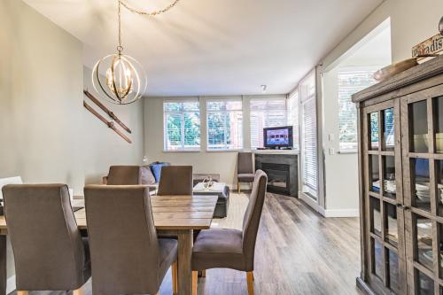 a dining room with a table and chairs and a television at Alpenglow Lodge by Elevate Vacations in Whistler