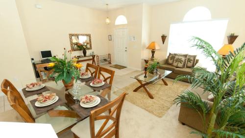 a living room with a dining room table and chairs at Luxury 5 Bedroom Villa with Secluded Pool/Spa in Glenbrook community near Orlando in Orlando