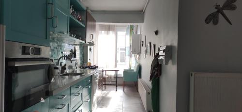 a kitchen with blue cabinets and a sink and a window at Private Room in Istanbul #54 in Istanbul