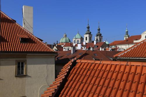 a view of roofs of a city with domes at Hotel King George in Prague