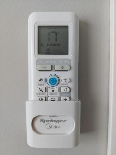 an electronic device with a clock on top of it at Apartamento frente à praia in Santos