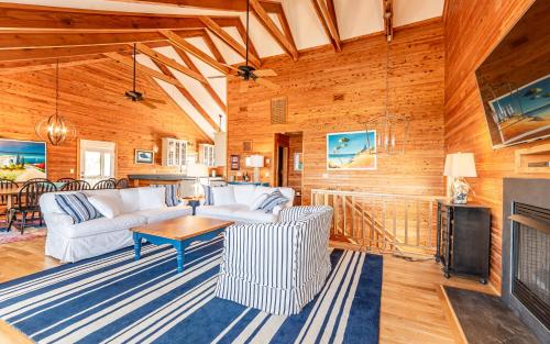 a living room with white furniture and a fireplace at Shore Enough in Sanderling