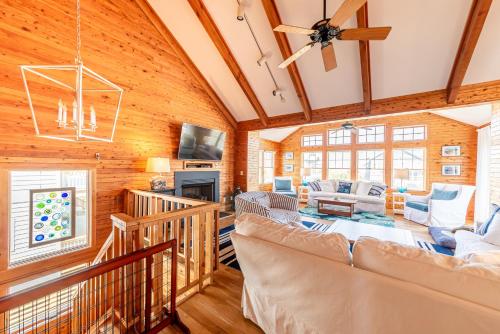 a living room with wooden walls and a ceiling at Shore Enough in Sanderling