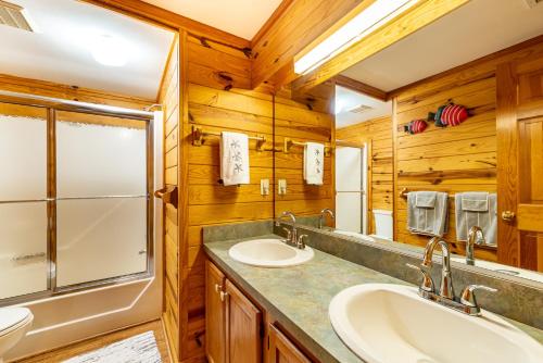 a bathroom with two sinks and a shower at Shore Enough in Sanderling