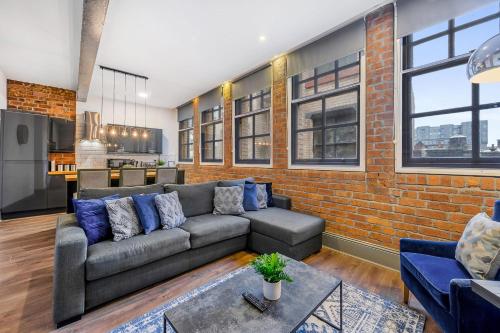 a living room with a couch and a brick wall at Host & Stay - Bands Warehouse V in Liverpool