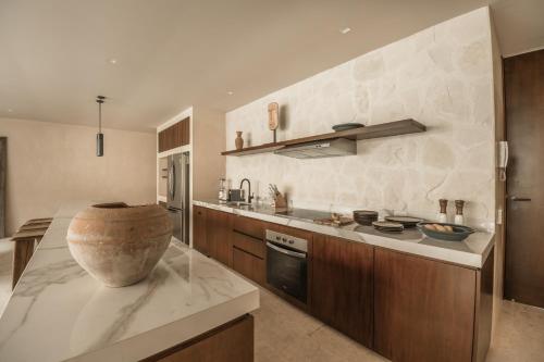 a kitchen with a large bowl on a counter at Exclusive Penthouse by Famous Interior Designer By Yeah in Tulum