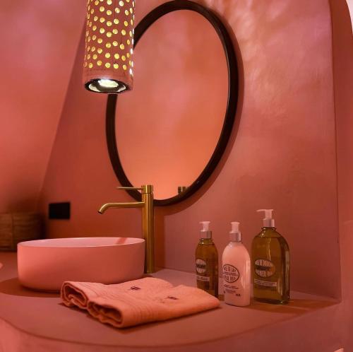 a bathroom with a sink and a mirror on a counter at Suite La Bonita 