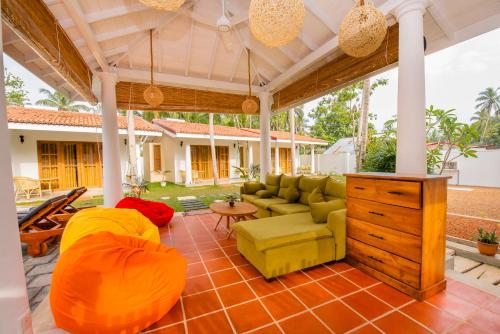 an outdoor living room with a couch and a table at Tree of Life Resort in Bentota