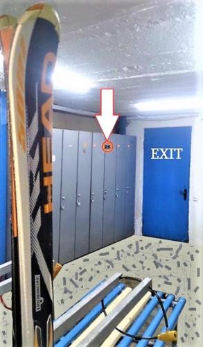 a room with an exit sign and a surfboard at "Gudauri Heart" Apartment in Gudauri