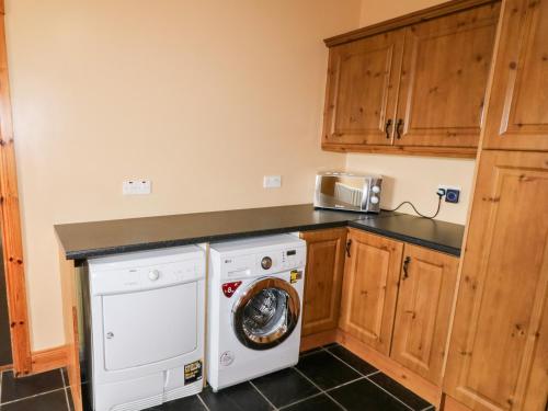 a laundry room with a washer and dryer at Willow Tree Farm House in Newry