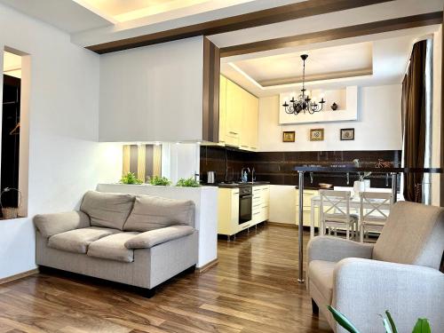 a kitchen with a couch and a table at Lux apartments in the city center, with a view of the theater, near Zlata Plaza in Rivne