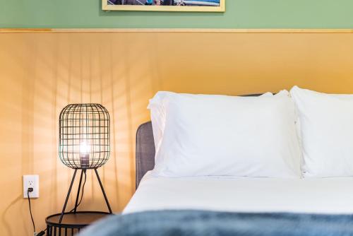 a bedroom with a bed with a lamp next to it at Casa Zamora by VH in Mexico City