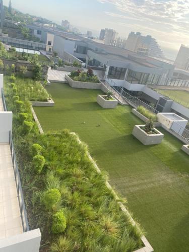 a rooftop garden on a building with grass and plants at 608 Beacon Rock in Durban