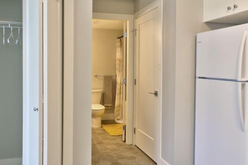 a bathroom with a white refrigerator and a toilet at Zen Retreat in Victoria