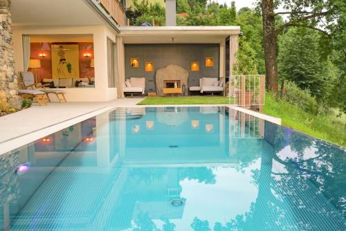a swimming pool in front of a house at Thombauer Hube in Sankt Johann im Saggautal