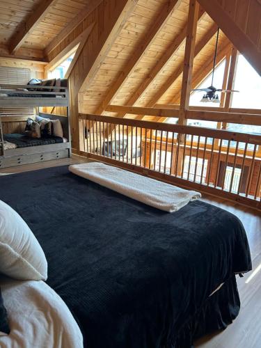 a bedroom with a large bed in a wooden ceiling at Classy Bear Cabin in Gatlinburg