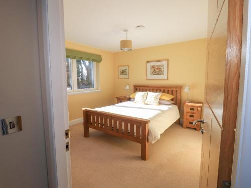 a bedroom with a bed and a window at Ferneytoun in Aboyne