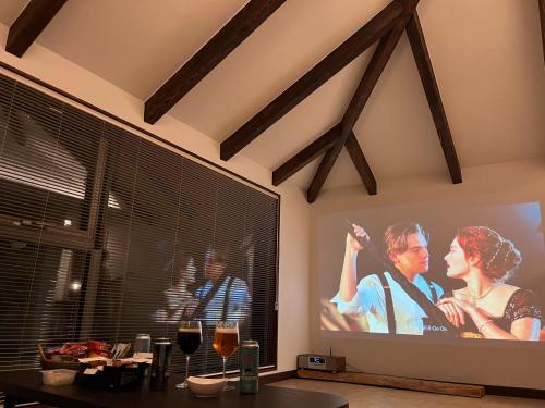 TV de pantalla grande en la sala de estar con una película en Juwoldam en Jeju