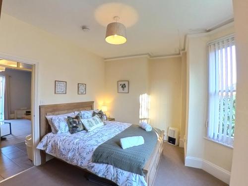 a bedroom with a bed with a blue comforter at The Ingleside Apartment in Basingstoke