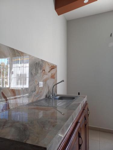 a kitchen with a sink and a counter top at Hotel y Plaza JMI in Siguatepeque