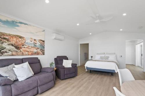 a living room with a couch and a bed at Port Lincoln Beachfront Apartment 7 in Port Lincoln