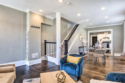 a living room with blue furniture and a staircase at Baltimore Vacation Rental Near Dtwn Towson! in Baltimore