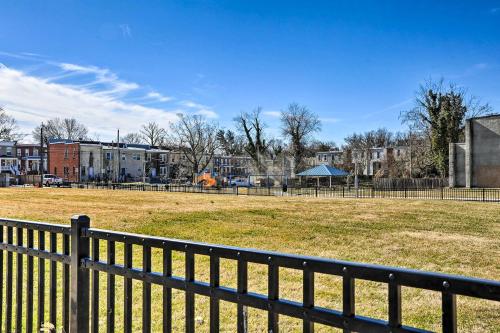 a black fence in front of a field with buildings at Baltimore Vacation Rental Near Dtwn Towson! in Baltimore