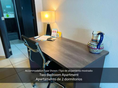 a desk with a vase sitting on top of it at Cárdenas Suites in Puerto Vallarta